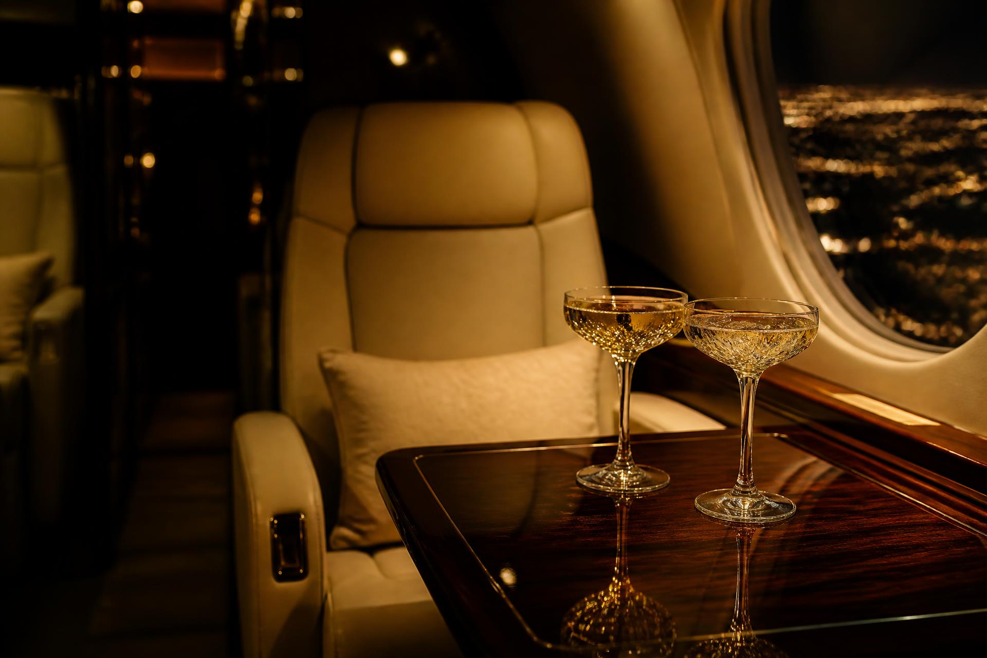 Champagne coupes in a private jet cabin